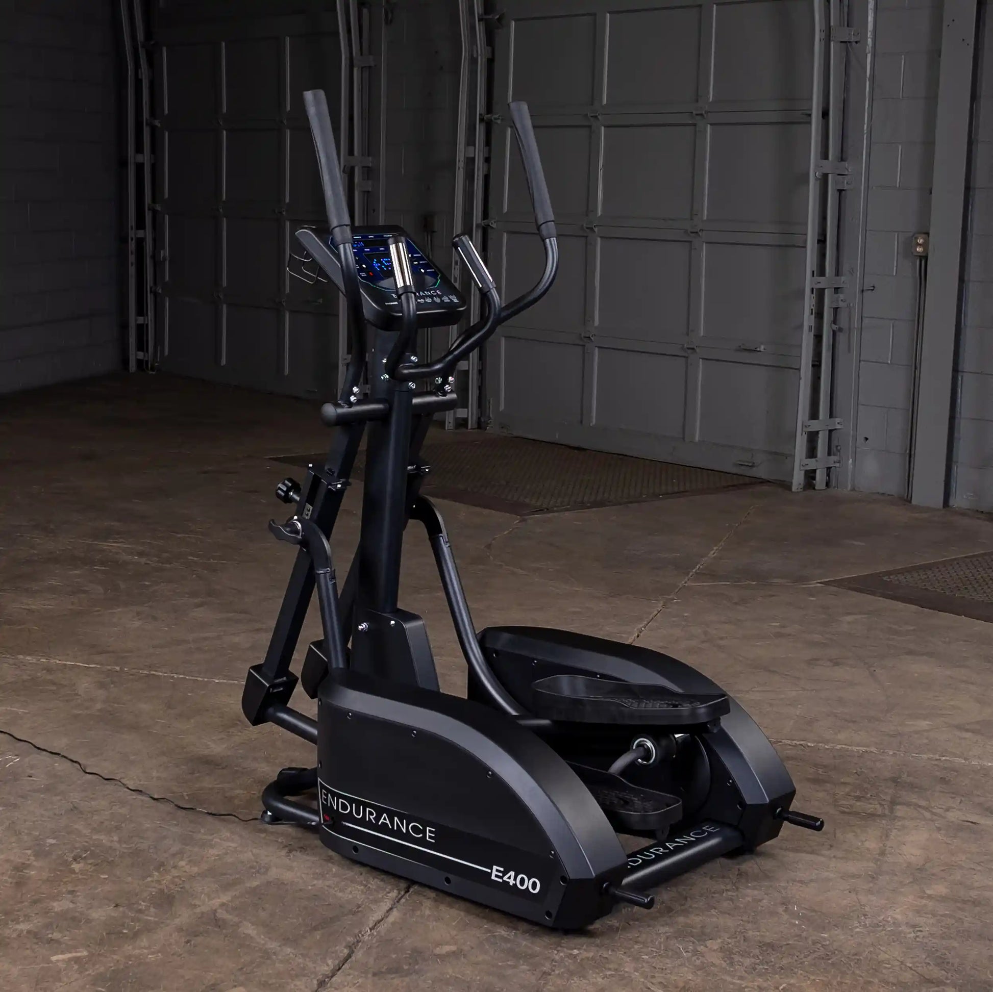 Endurance E400 elliptical trainer in black with digital display in a garage setting.