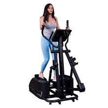 Woman exercising on Endurance E400 elliptical trainer, wearing blue leggings.