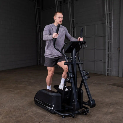Man exercising on Endurance E400 elliptical trainer in a gym.