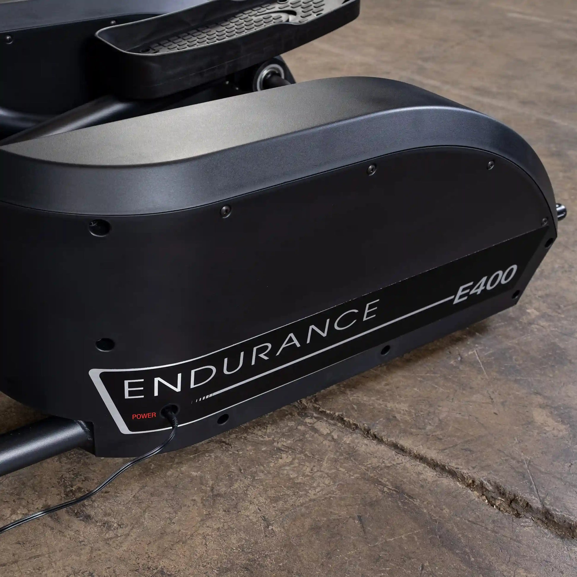 Endurance E400 exercise bike with sleek black design on a wooden floor.
