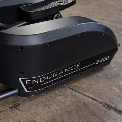 Endurance E400 exercise bike with sleek black design on a wooden floor.