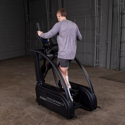 Man using Endurance E5000 elliptical trainer in a gym.