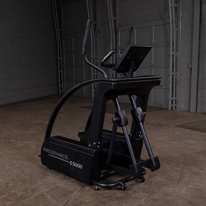 Endurance E5000 elliptical machine in black with a sleek design in a warehouse setting.