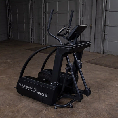 Endurance E5000 elliptical trainer in black with advanced digital display in a garage gym setting.