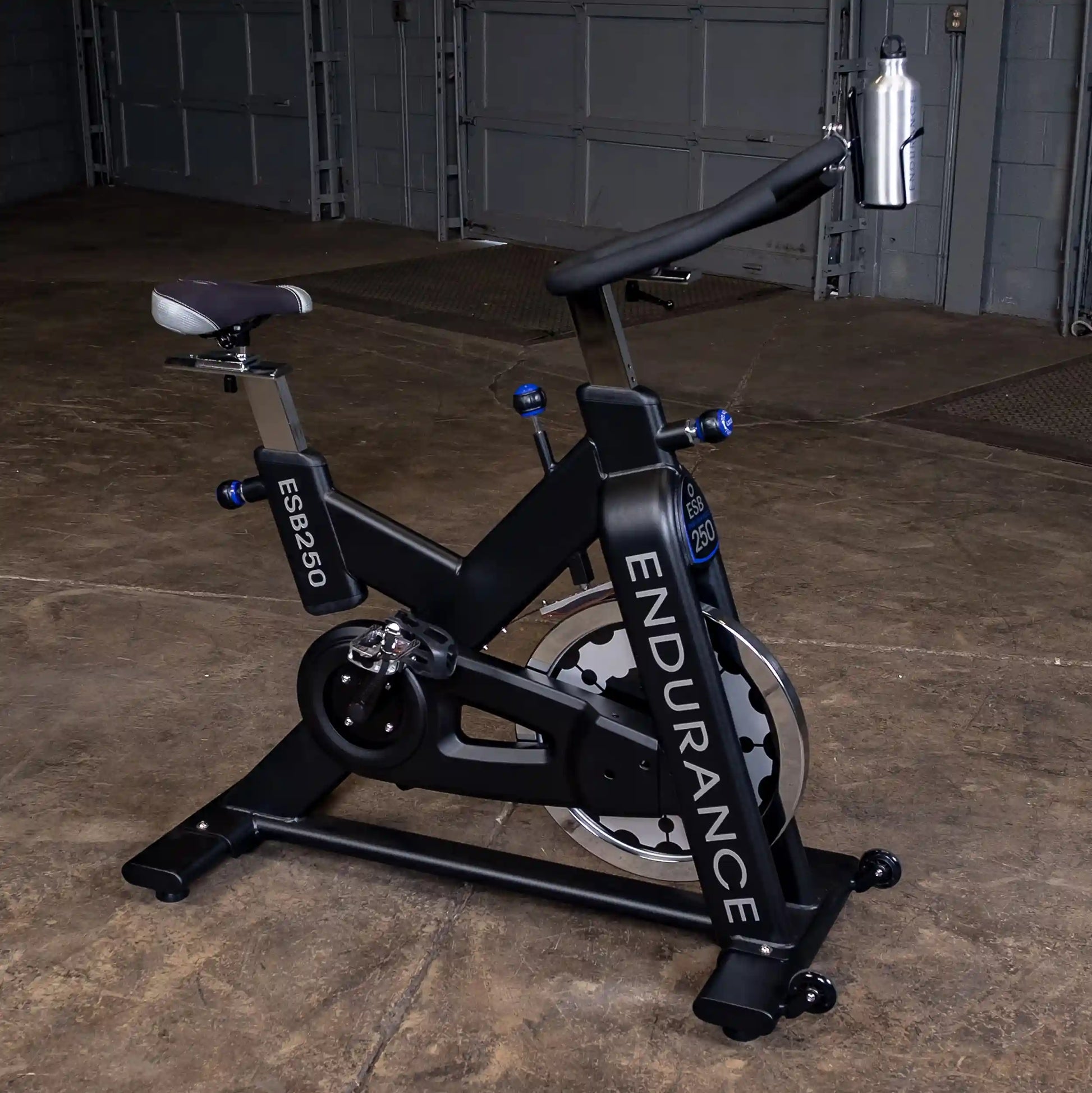 Endurance ESB250 stationary bike with black frame and attached water bottle in a garage setting.