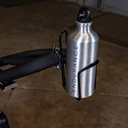 Silver ENDURANCE water bottle mounted on a bike handlebar with black holder.