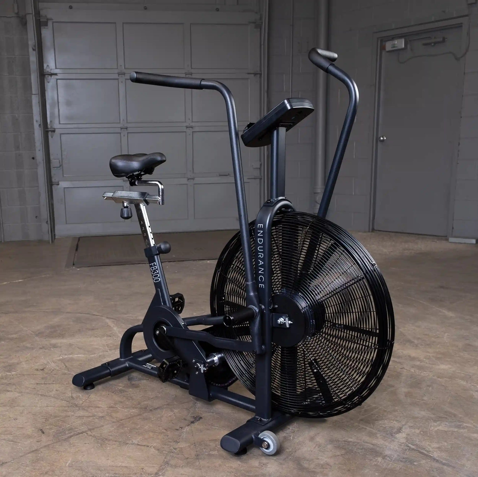 Endurance FB300 air bike with black frame in a concrete room.