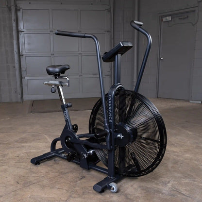 Endurance FB300 air bike with black frame in a concrete room.