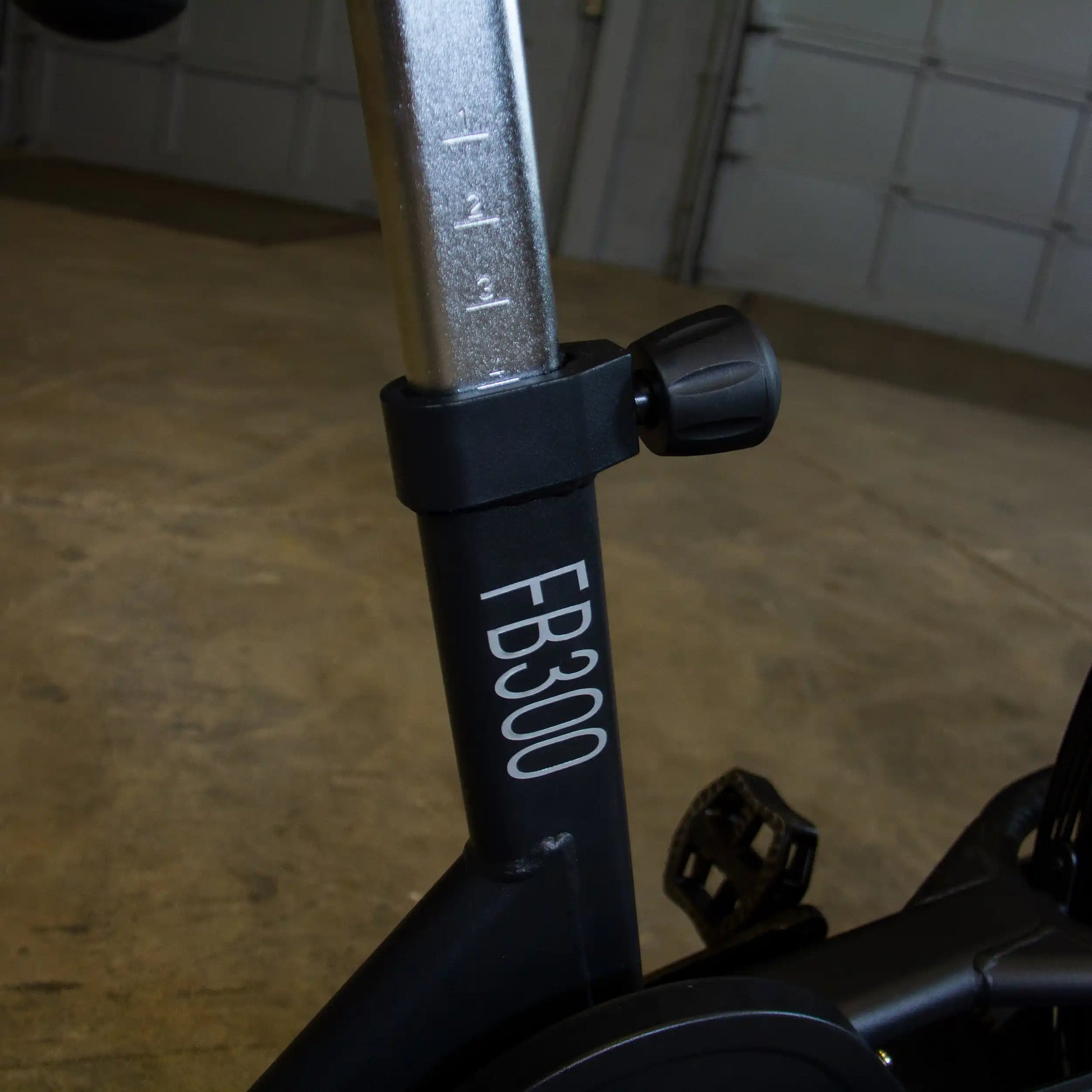 FB300 exercise bike seat adjustment knob with height markings.