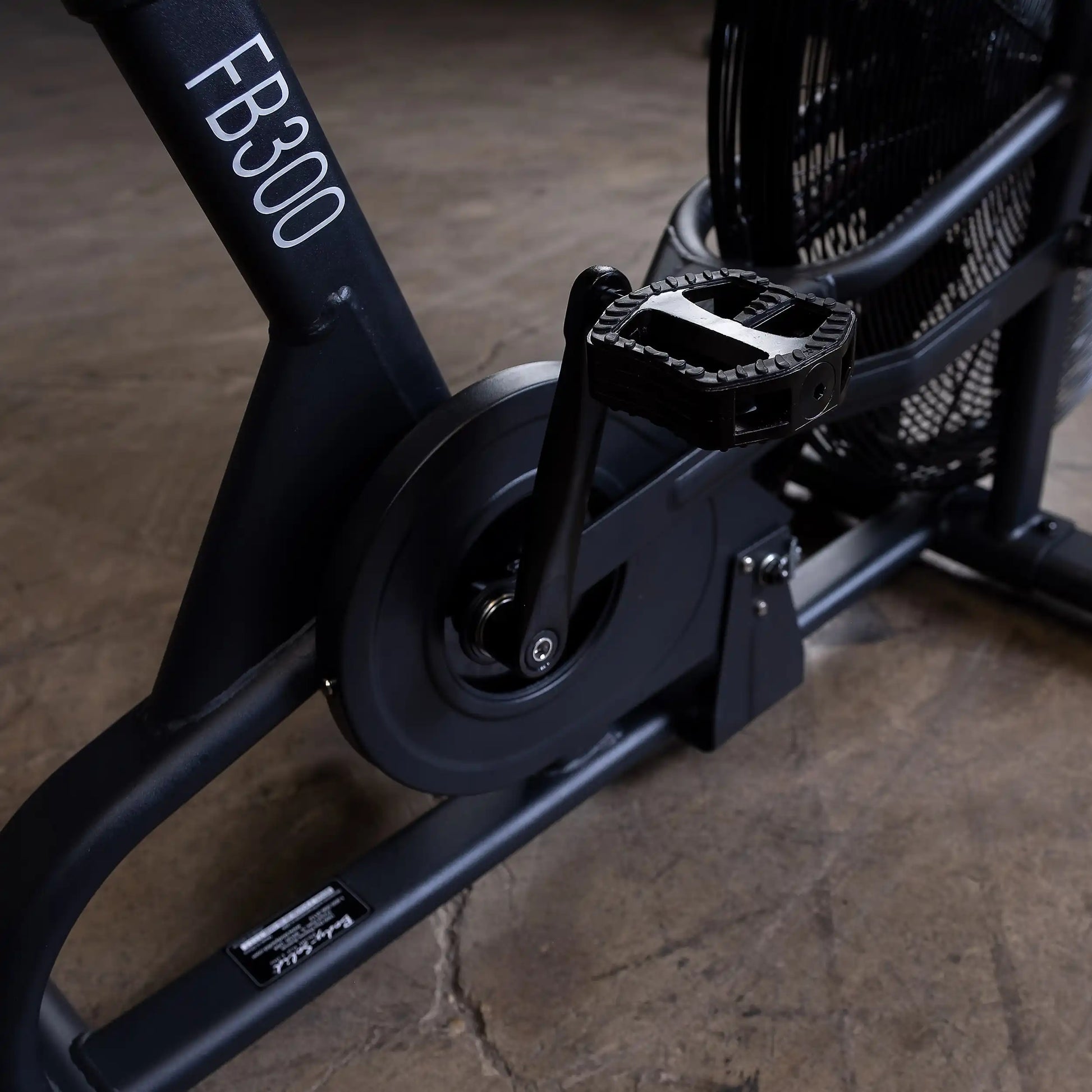 FB300 exercise bike pedal and fan detail on a concrete floor.