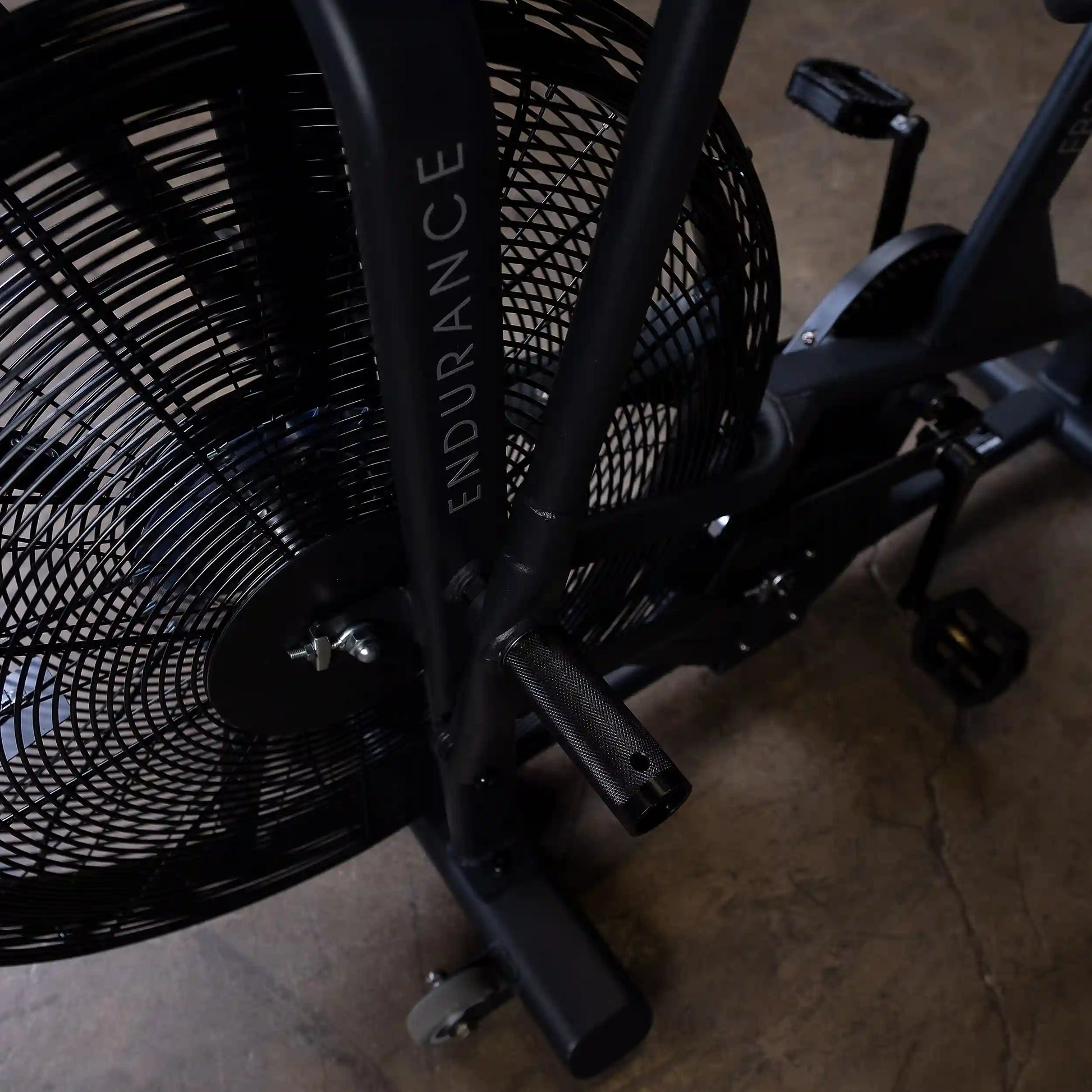 Endurance exercise bike with black fan and pedals for cardio workouts.