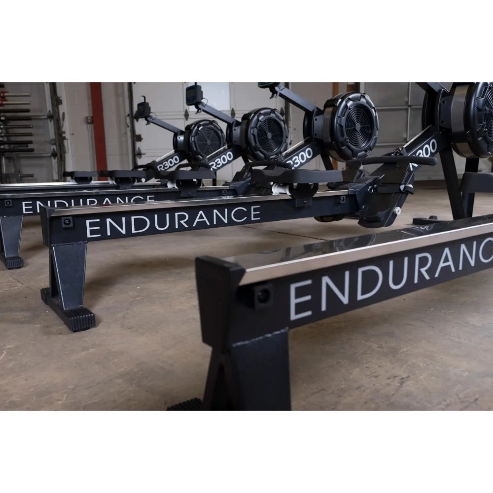 Endurance R300 rowing machines with sleek black frames in a gym setting.