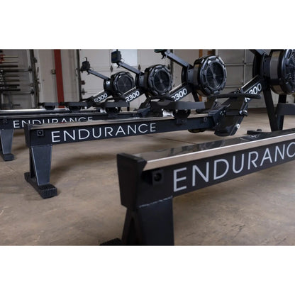 Endurance R300 rowing machines with sleek black frames in a gym setting.