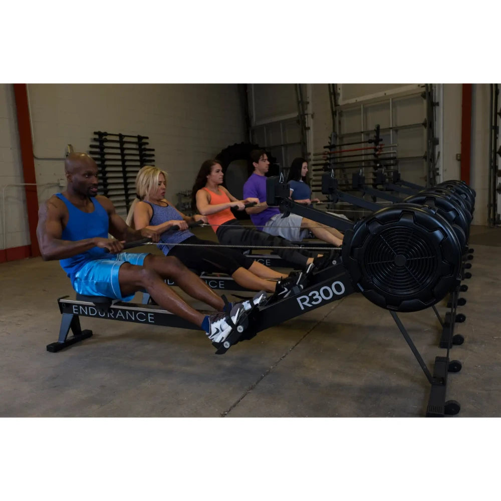 People exercising on Endurance R300 rowing machines in a gym.