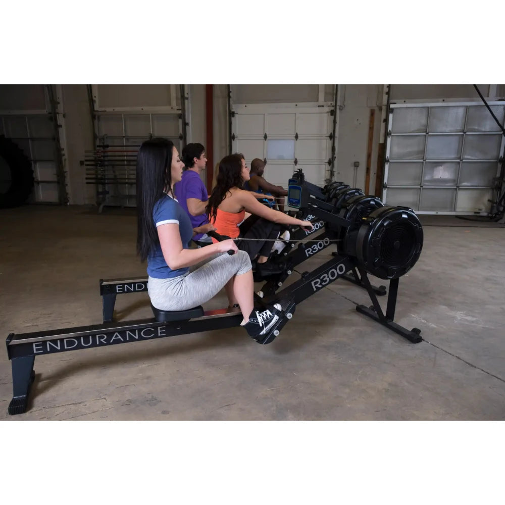 People using Endurance R300 rowing machines in a gym.
