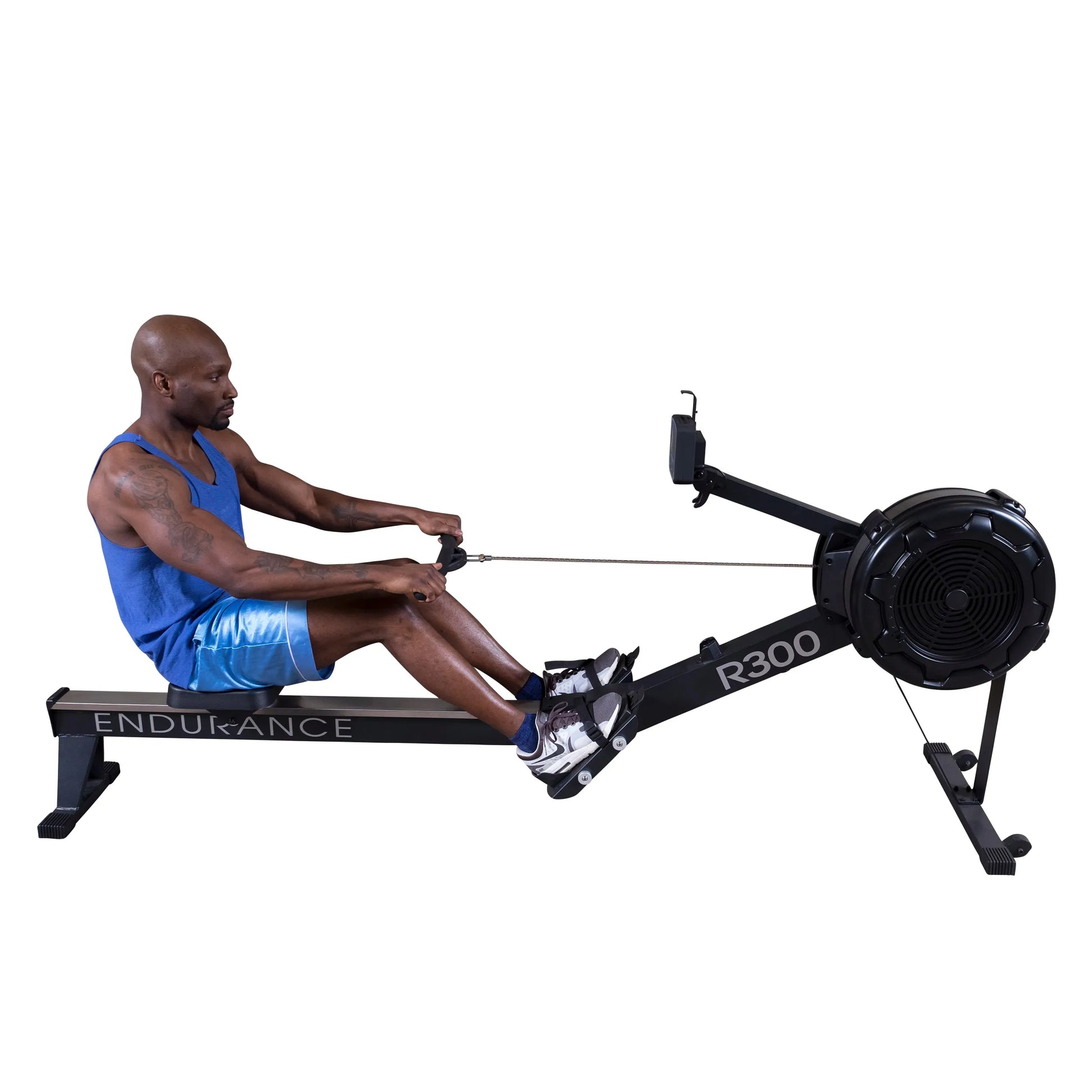 Man exercising on Endurance R300 rowing machine in blue athletic wear.