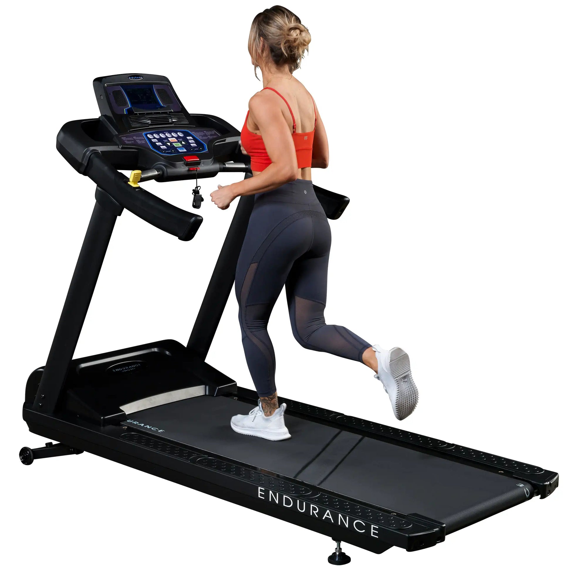 Woman running on black Endurance treadmill in red top and leggings.