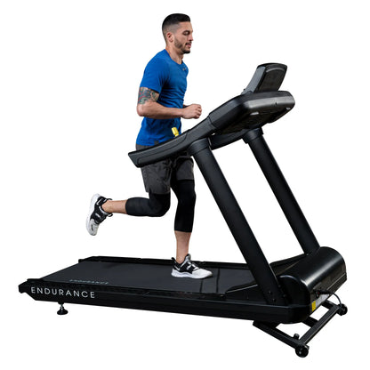 Man running on black Endurance treadmill wearing blue shirt and black leggings.