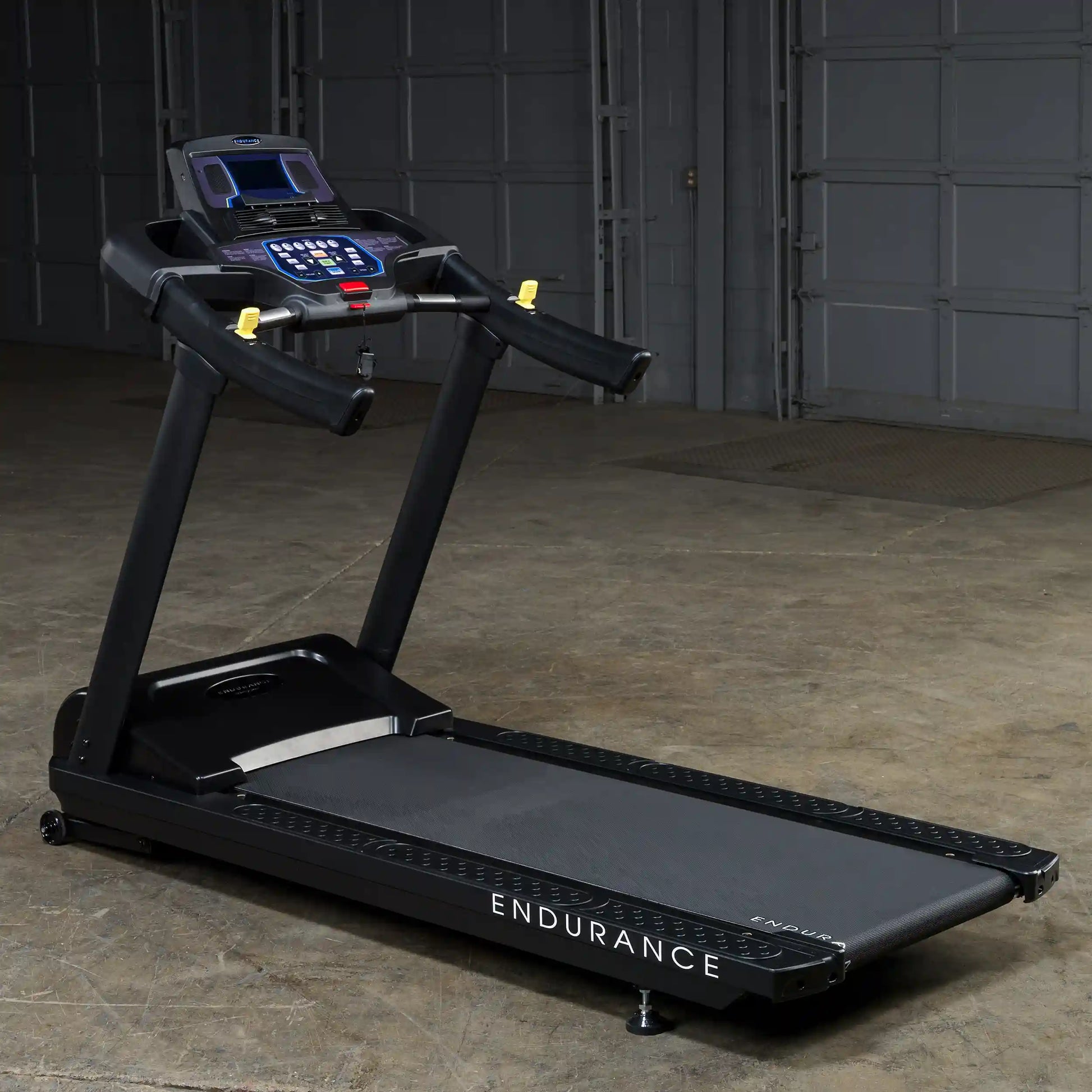 Endurance treadmill with digital display and black finish in a garage setting.