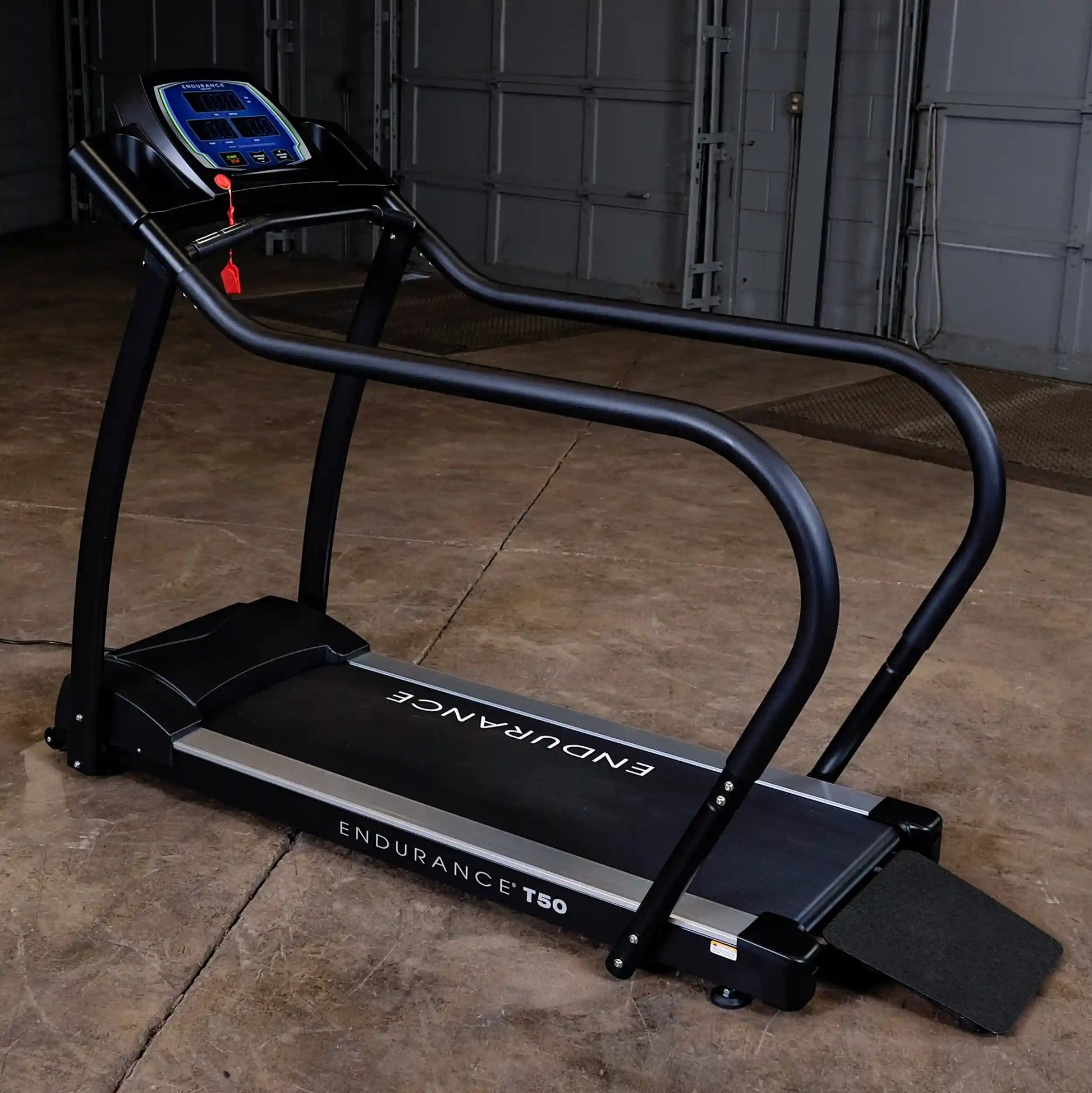 Endurance T50 treadmill with black frame and digital display in a garage setting.