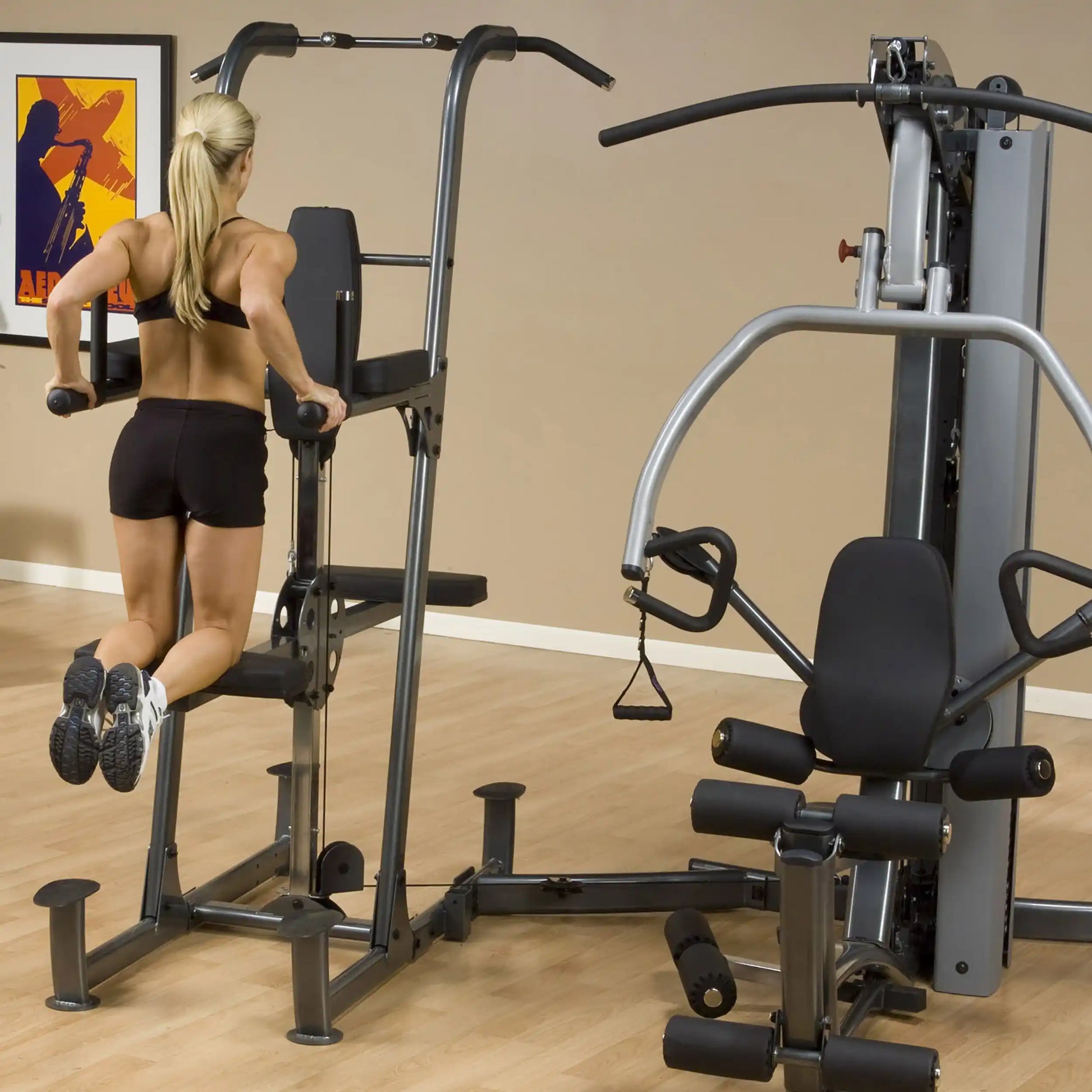 Woman using Body-Solid gym equipment for tricep dips in a home workout room.