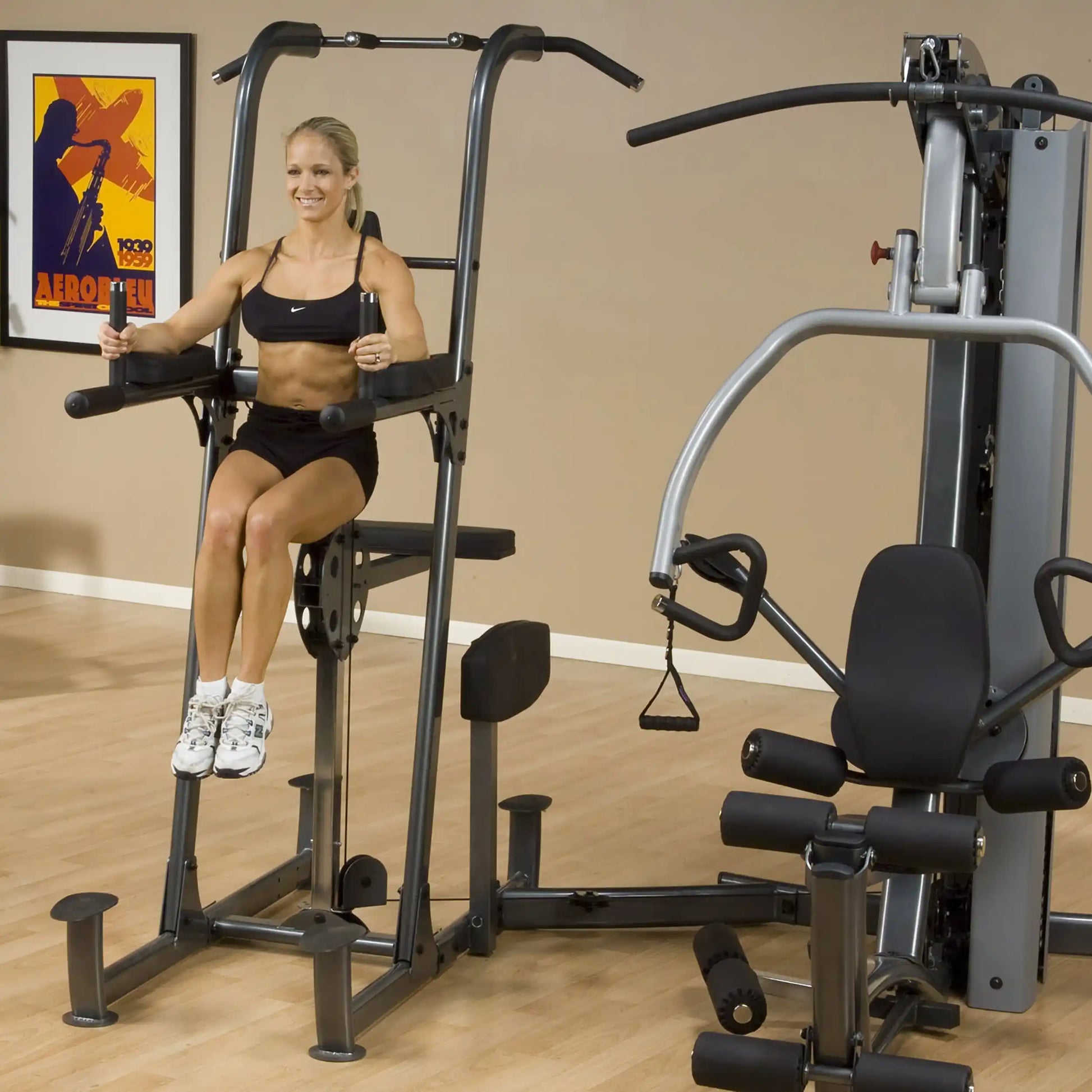 Woman using Body-Solid knee raise machine in home gym.
