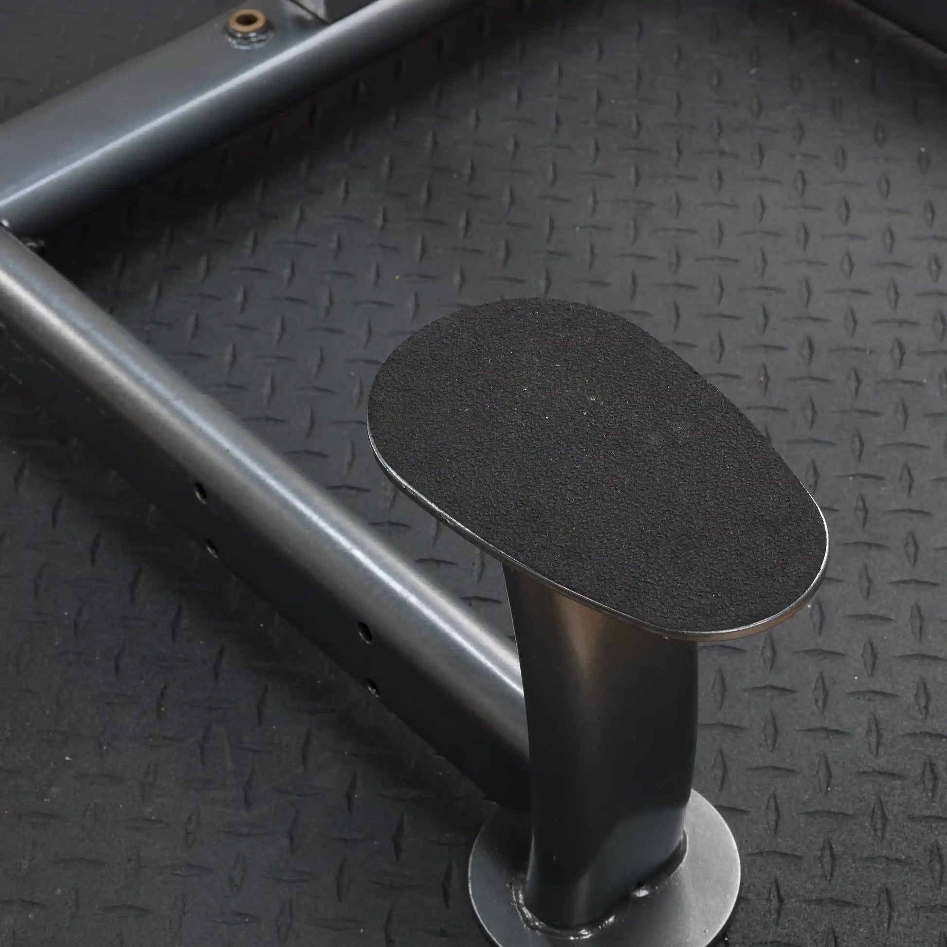 landmine platform with textured black grip on diamond plate flooring.