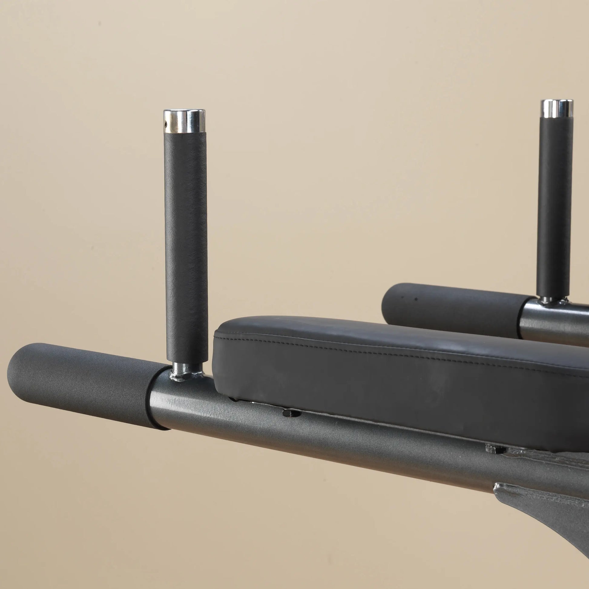 Black leather weightlifting bench with padded arm supports.