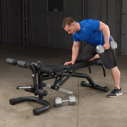 Man in blue shirt using adjustable weight bench for dumbbell exercise.