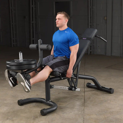 Man using Body Champ leg extension machine in blue shirt.