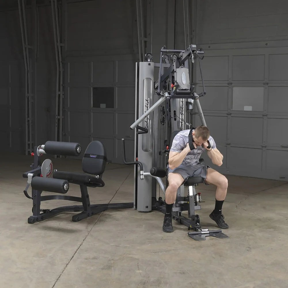 Man using Body-Solid G9S home gym with gray finish for strength training.