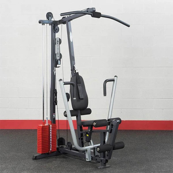 Home gym equipment with red weight stack and multi-exercise capability, ideal for full-body workouts.