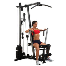 Woman exercising on a home gym machine in red sportswear.