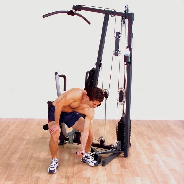 Man using a Body-Solid home gym machine for strength training.