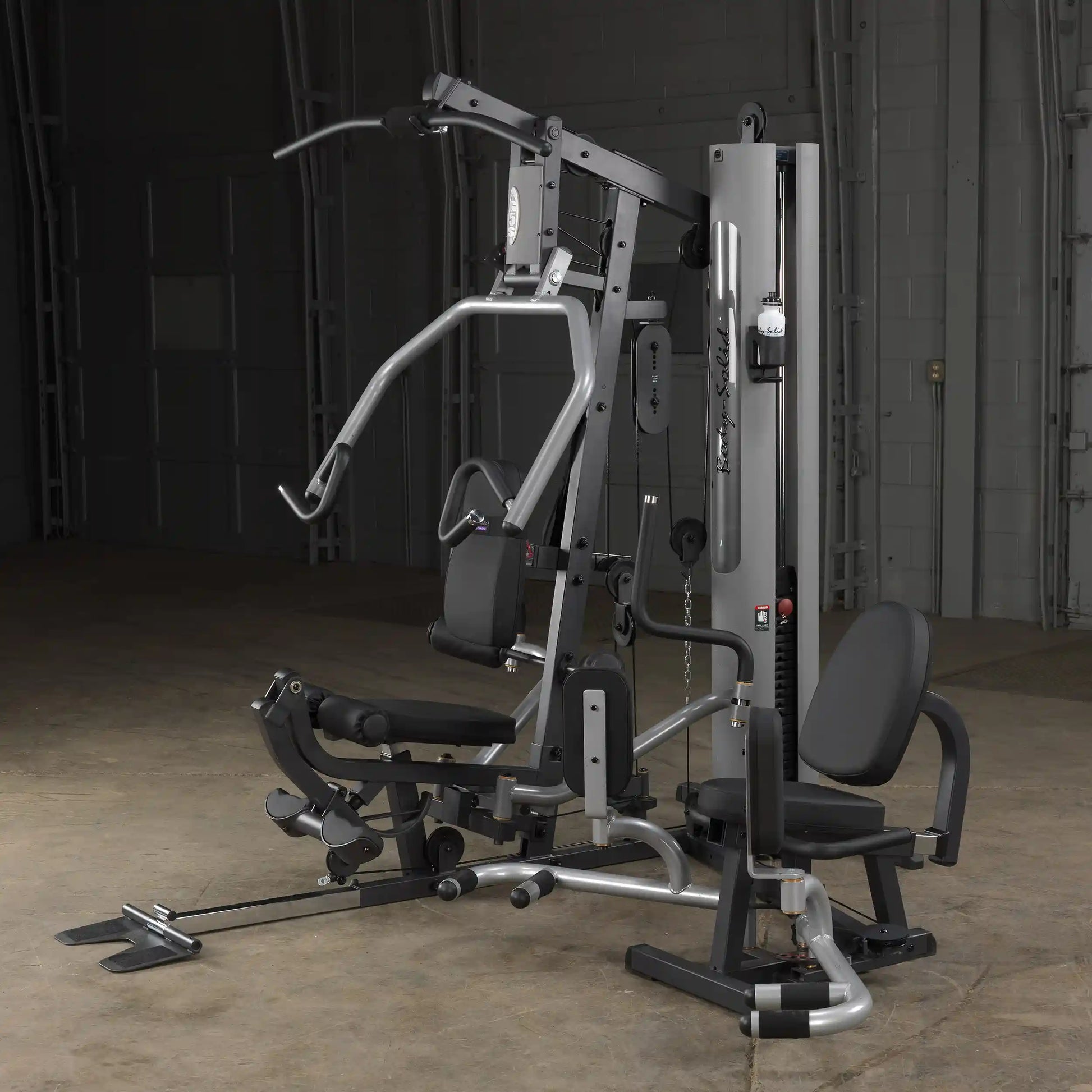Body-Solid home gym with black cushioned seats and multi-station weight system for versatile workouts.