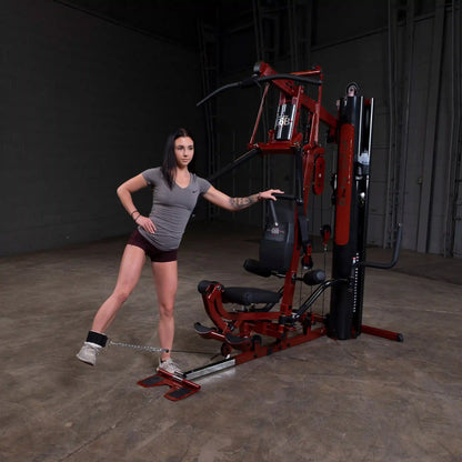 Woman using Inspire Fitness M3 Home Gym in a warehouse setting.