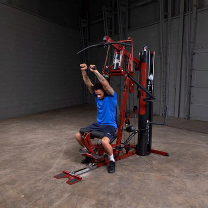 Man using red home gym equipment for strength training.