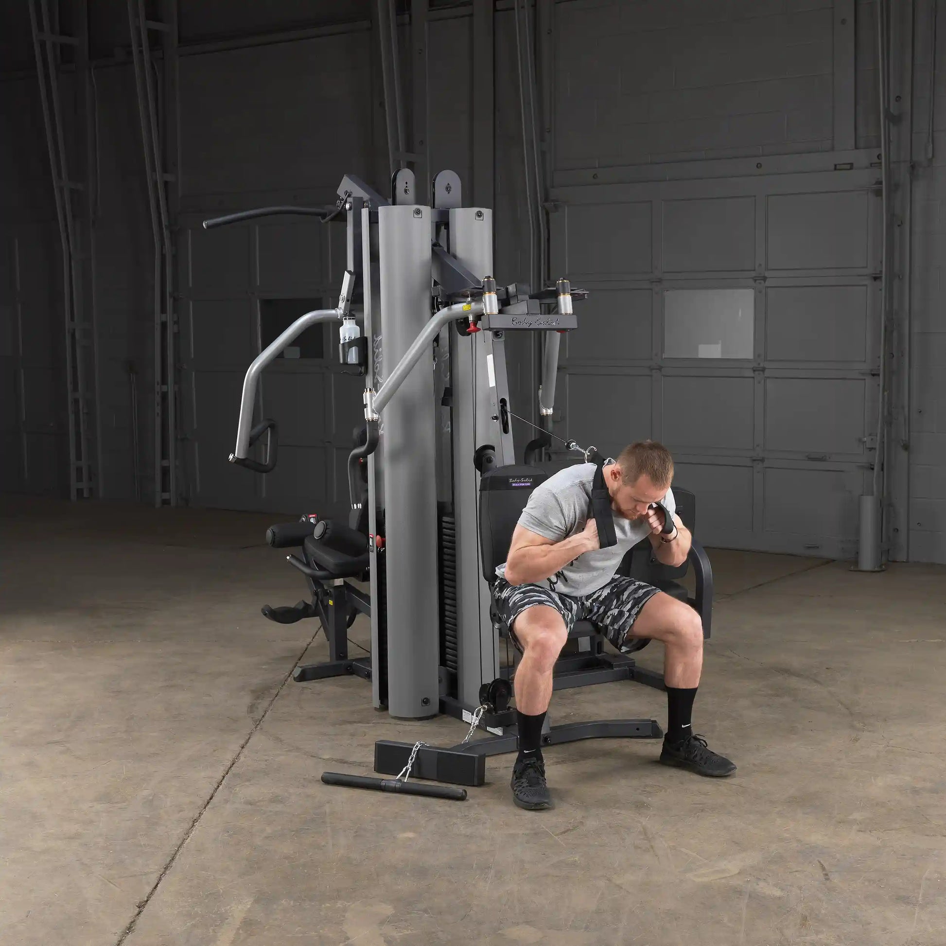 Man using Body-Solid G9S Home Gym in gray for strength training.