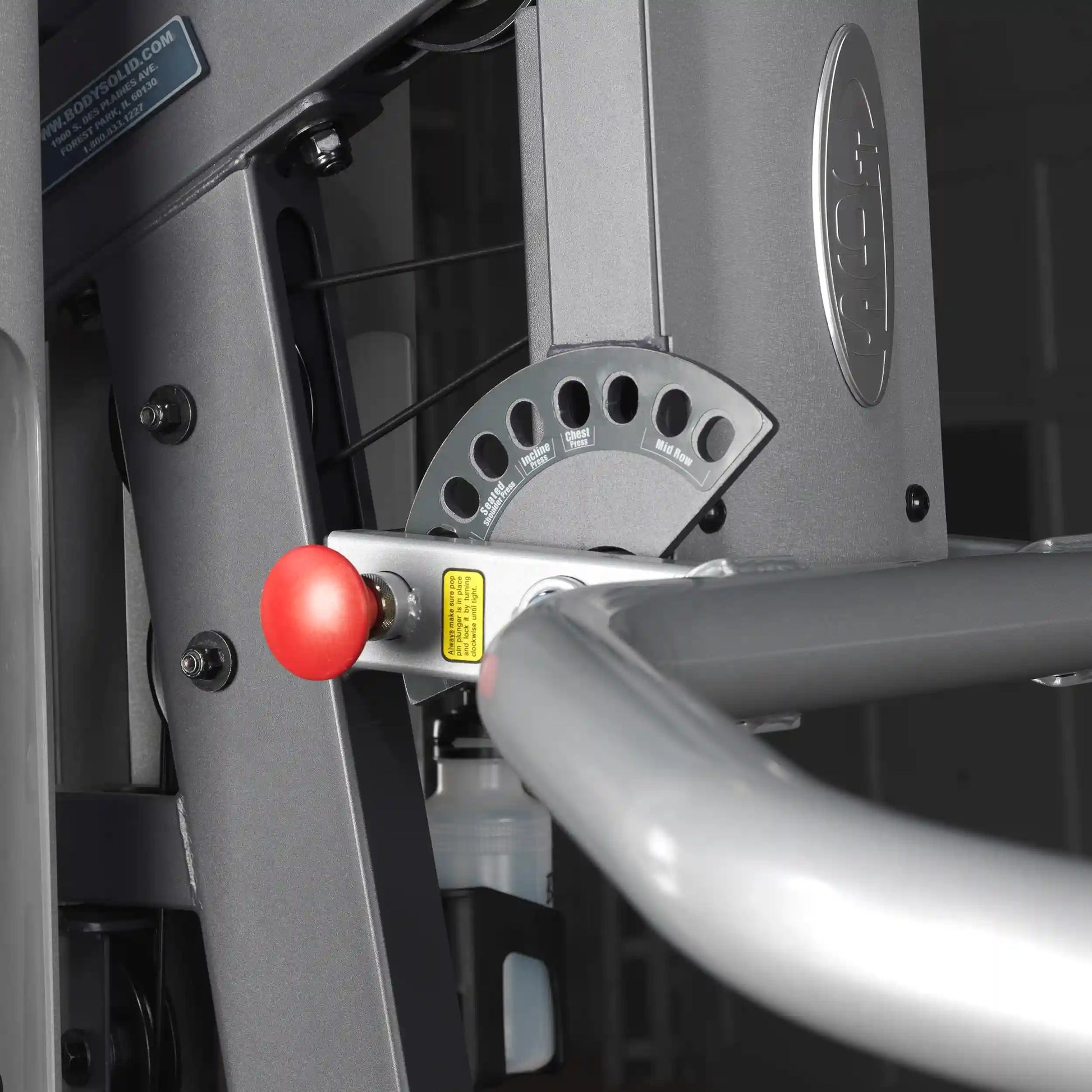 Body-Solid gym equipment with adjustable settings and red knob for strength training.