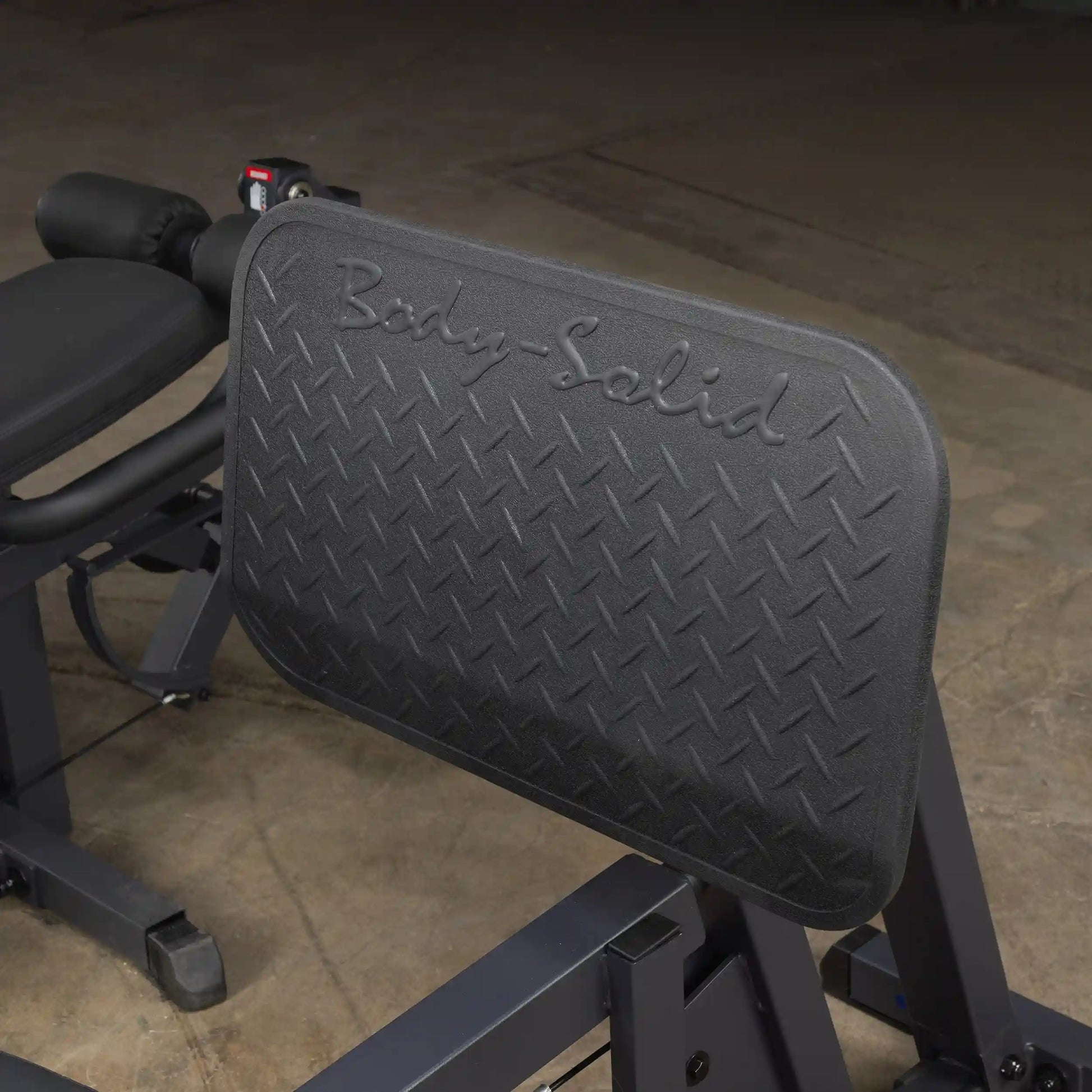 Body-Solid leg press machine with diamond-patterned footplate for enhanced grip.