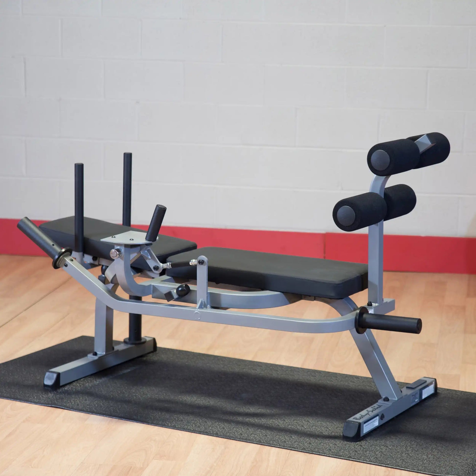 Adjustable weight bench with black padding and leg support, ideal for home gym workouts.