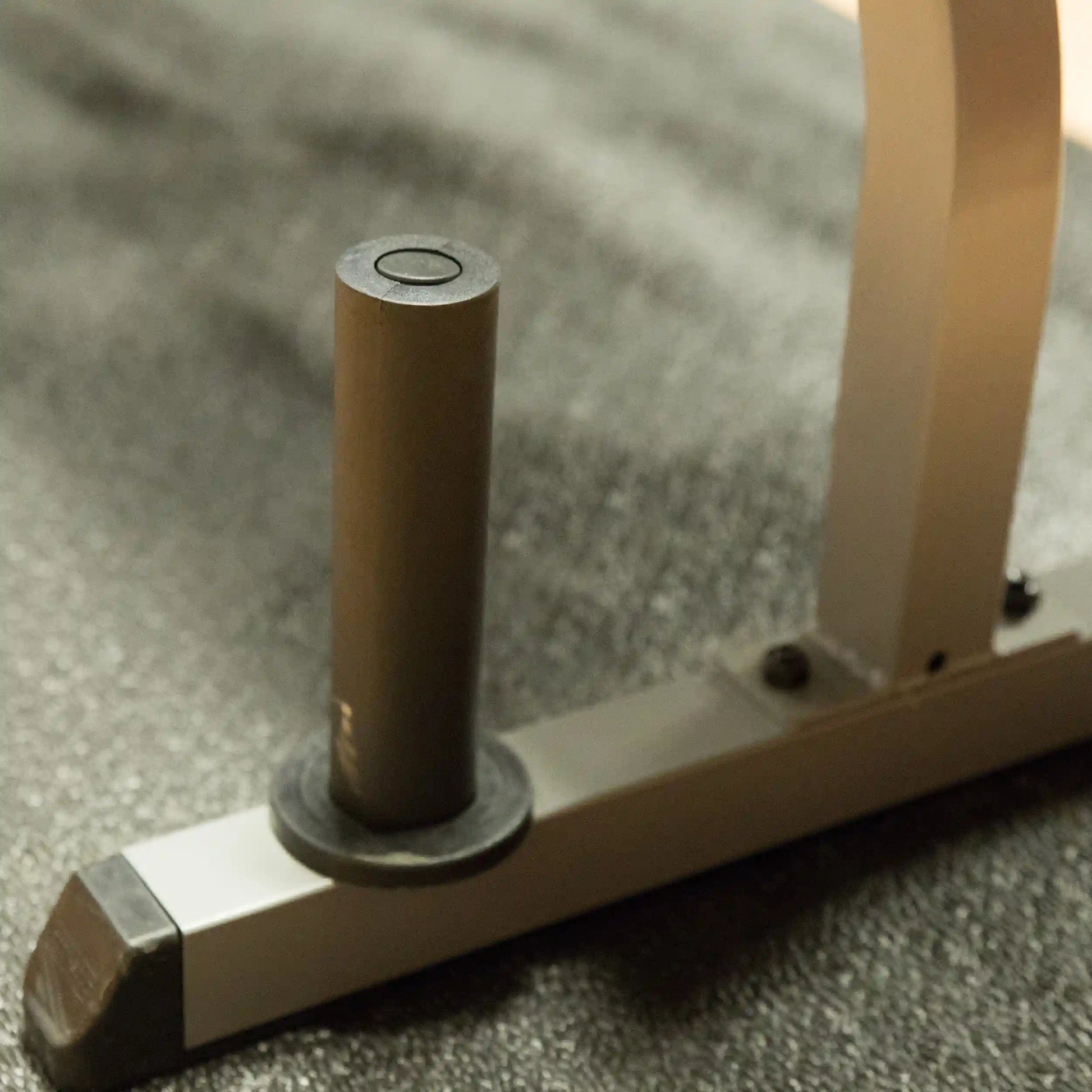 Weight plate holder on a metallic gym rack.