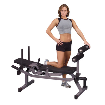 Woman using Valor Fitness adjustable weight bench, wearing gray and black workout attire.