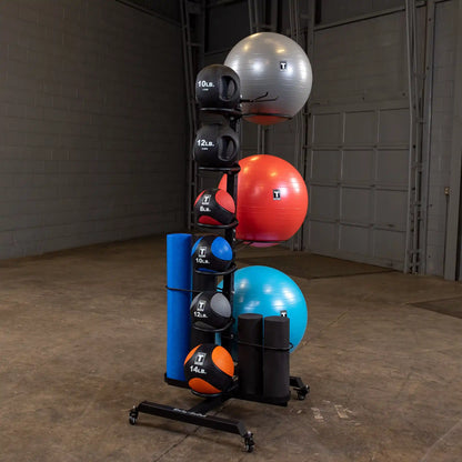 storage rack with stability balls, kettlebells, and foam rollers in a gym setting.