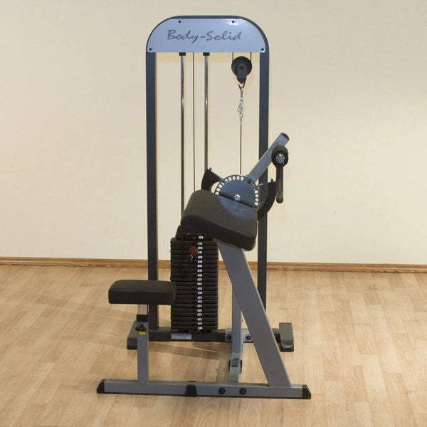Body-Solid preacher curl machine with adjustable weight stack on wooden floor.