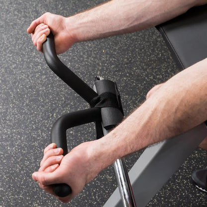 Man using black bicep isolator for weightlifting on gym floor.