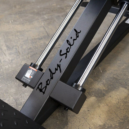 Body-Solid weight machine with sleek chrome rods on a concrete floor.