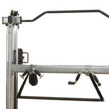 Pilates Cadillac frame with black straps and chrome handles for versatile workouts.