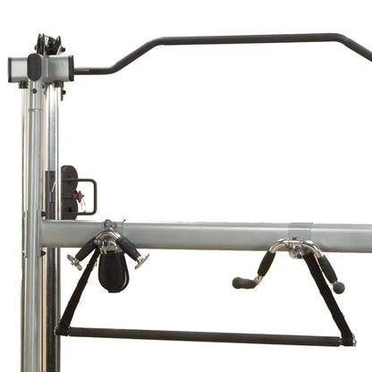 Pilates Cadillac frame with black straps and chrome handles for versatile workouts.