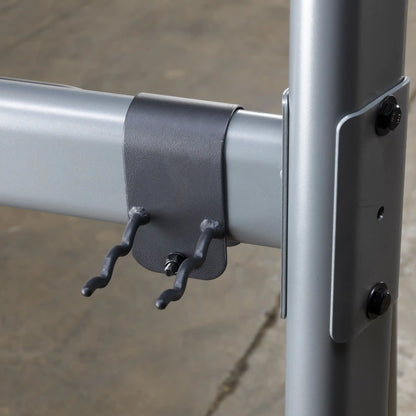 Gray metal clamp with two hooks on a steel frame, ideal for industrial shelving support.